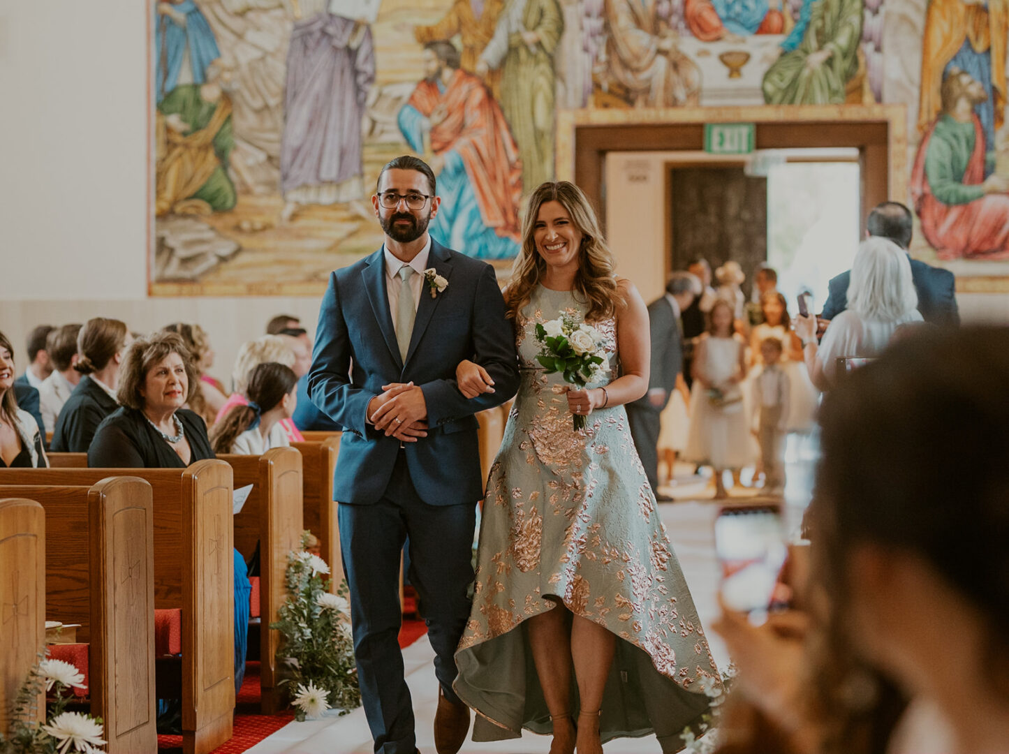 A man and woman walking down the aisle.