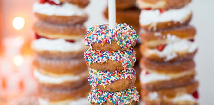 A stack of donuts with colorful sprinkles on top.