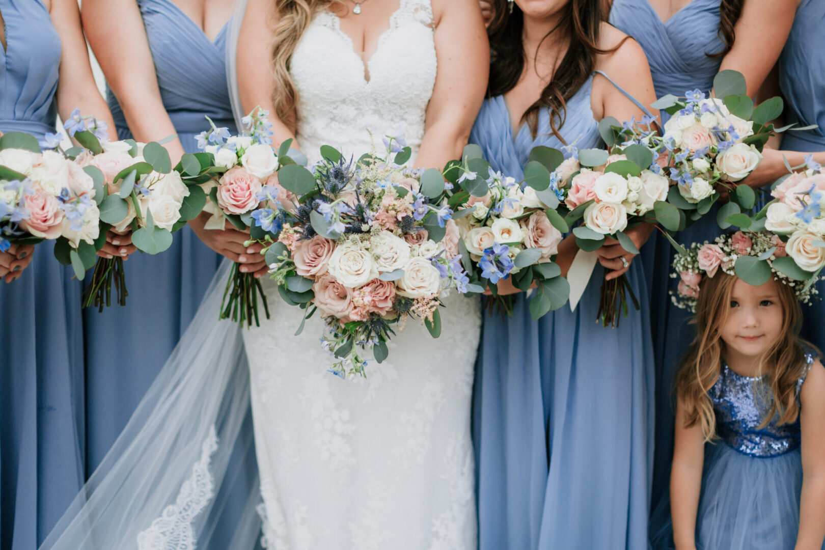 A bride and her bridesmaids holding their bouquets.