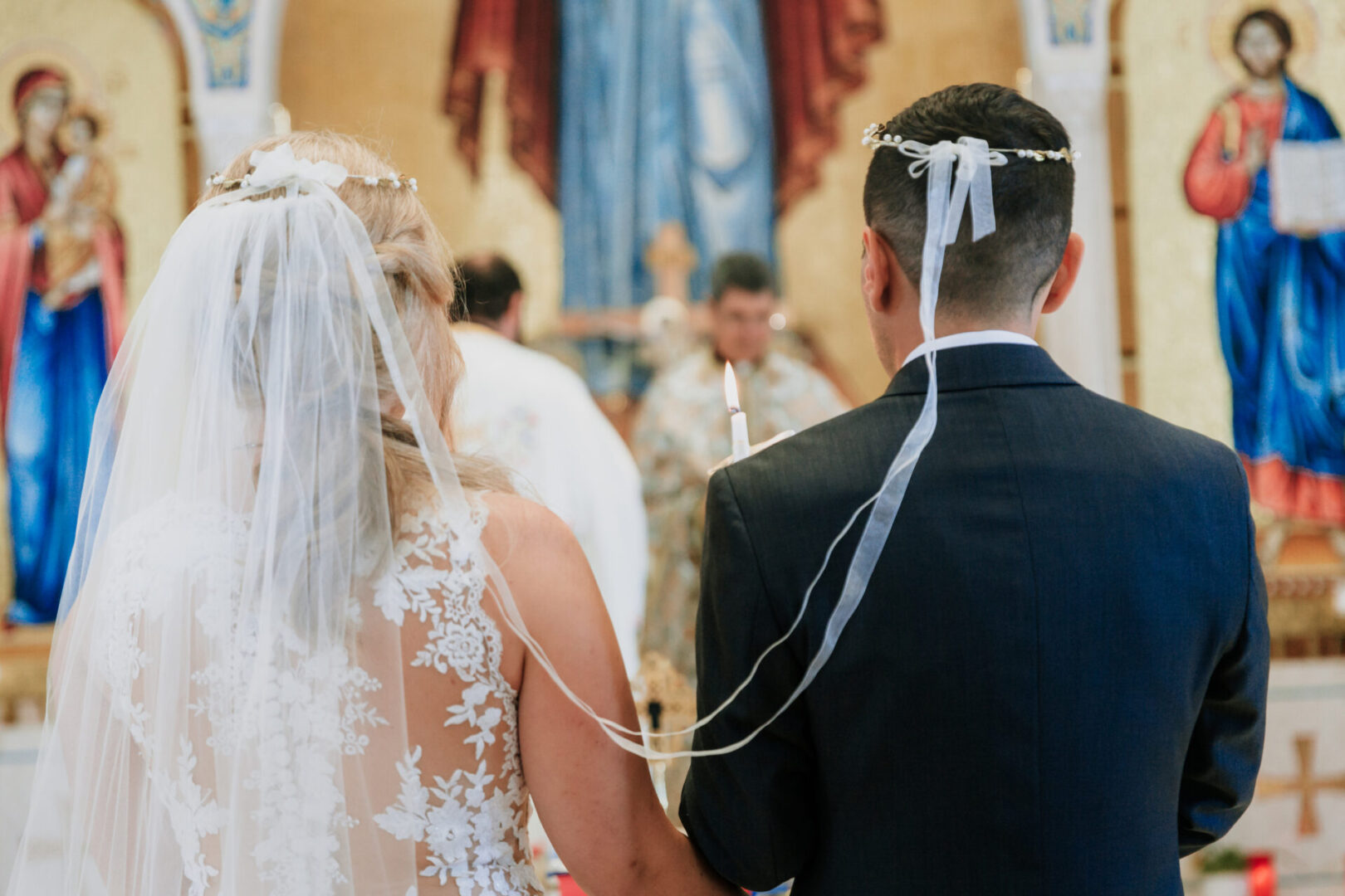 A bride and groom holding hands in front of the altar.