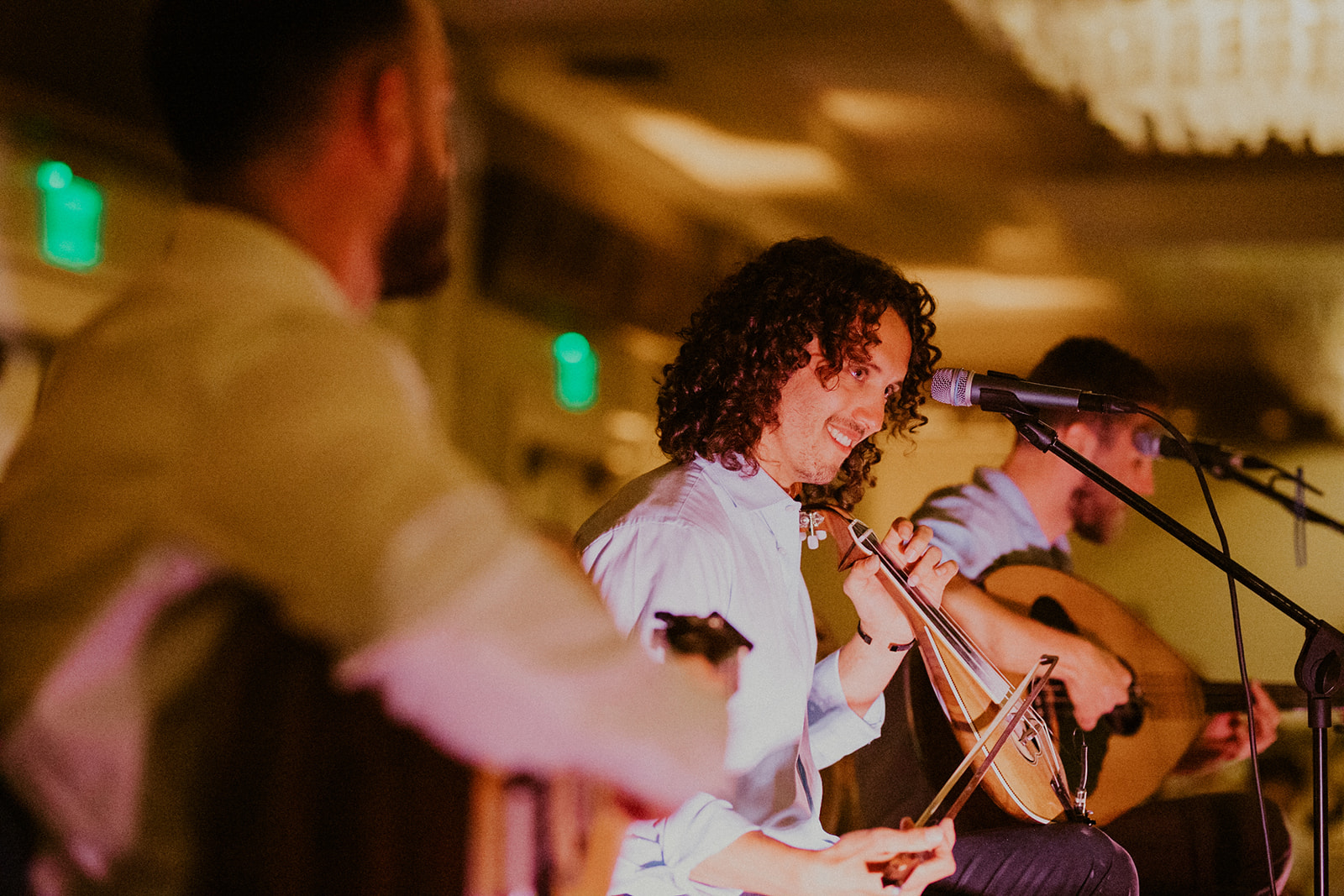 A group of people playing instruments in front of a crowd.