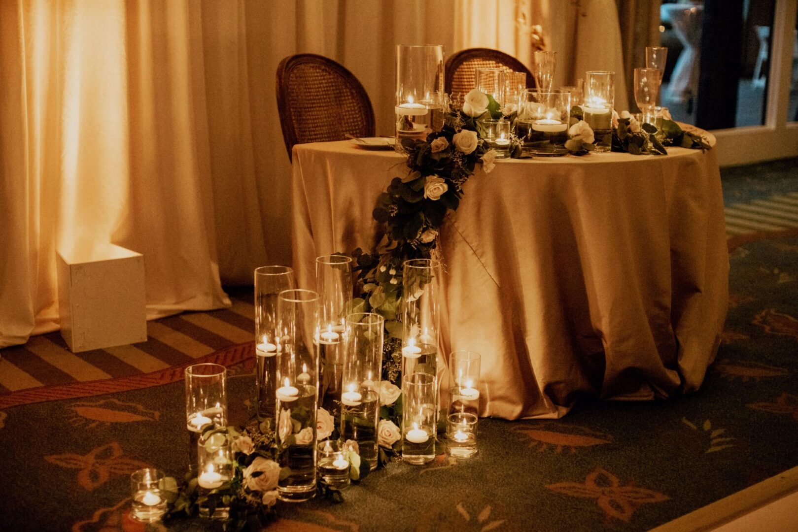 A table with candles and flowers on it