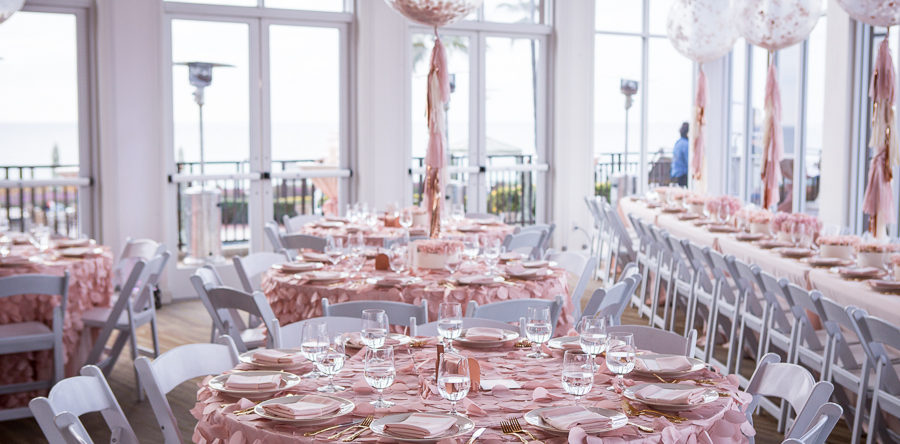 A table set up with pink plates and napkins