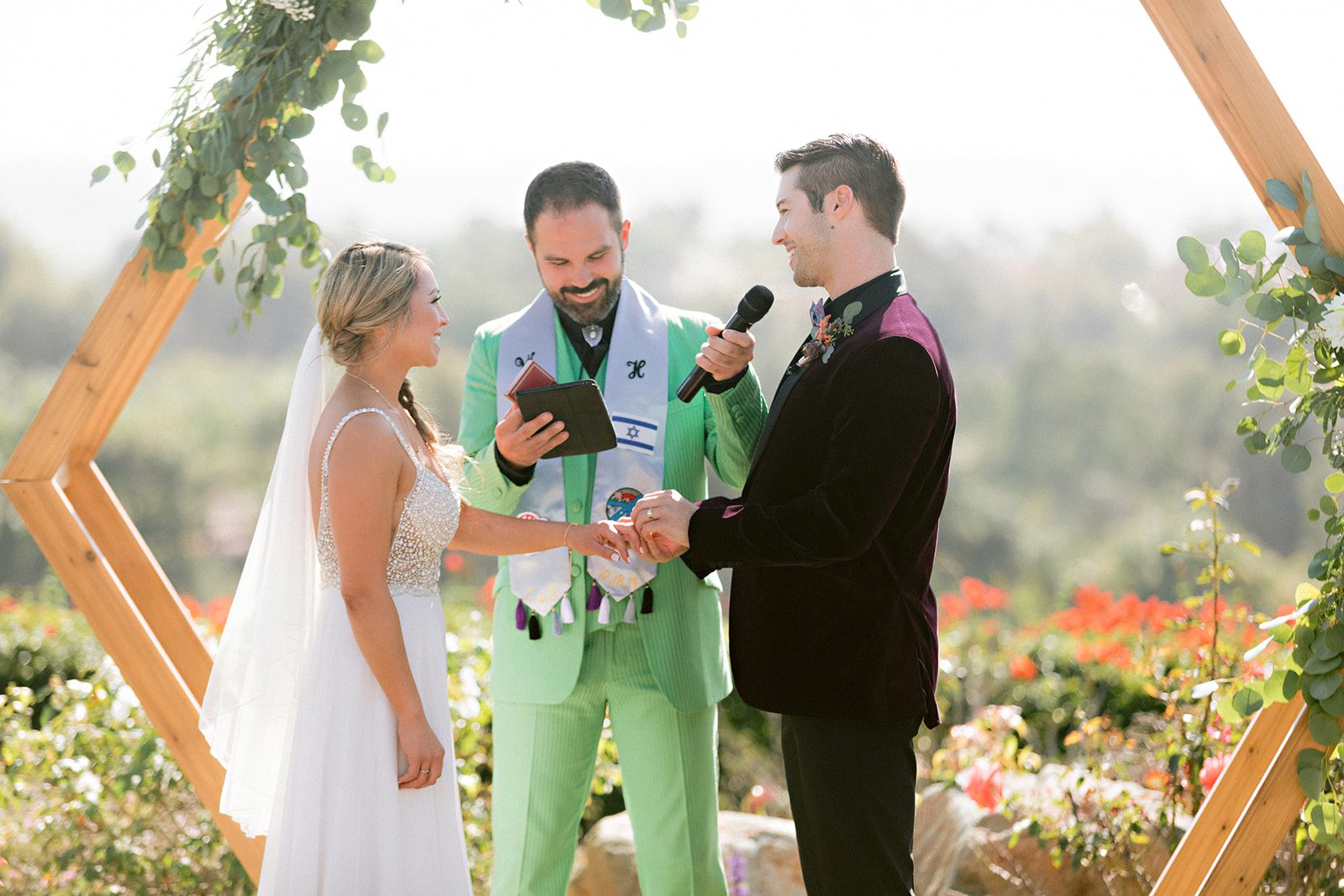 A man and woman are holding hands while standing next to each other.