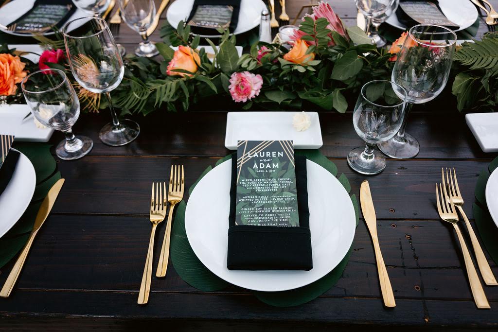 A table set with plates, silverware and glasses.