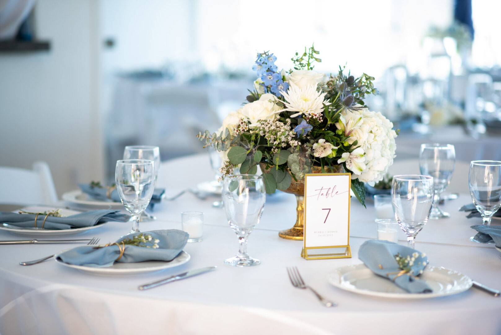 A table set with plates, silverware and napkins.