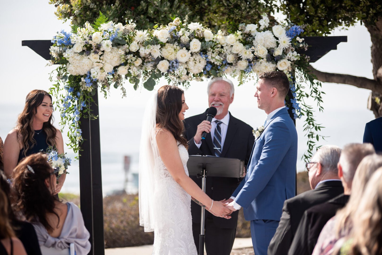 A man and woman are holding hands at their wedding.