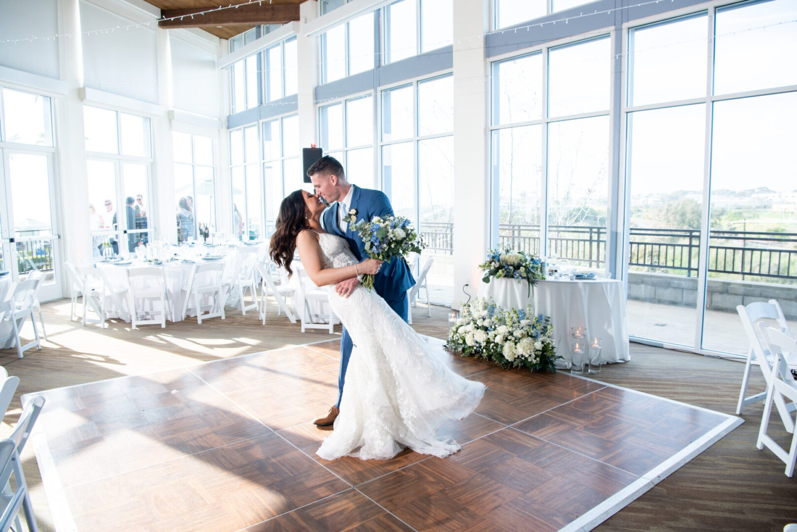 A bride and groom kissing on the dance floor.