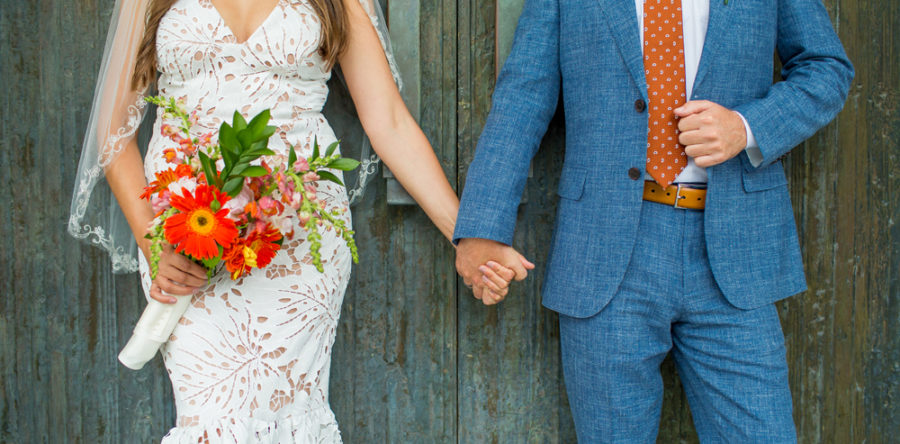 A man and woman holding hands while standing next to each other.