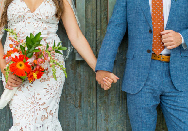 A man and woman holding hands while standing next to each other.